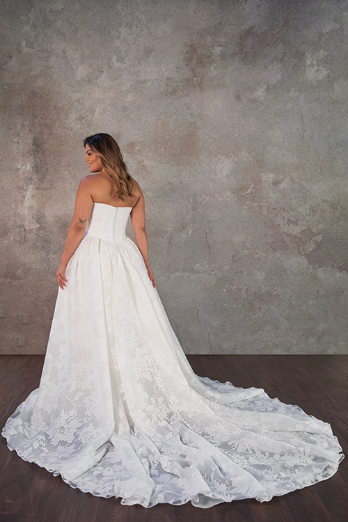 model is wearing a strapless basque waist bridal gown