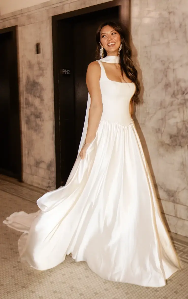 model is wearing a sleeveless square neckline a-line basque waist wedding dress