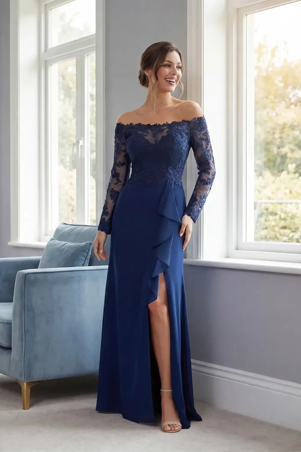 A woman in a navy blue off-the-shoulder gown with lace detailing and a thigh-high slit, standing in a bright room near a window.