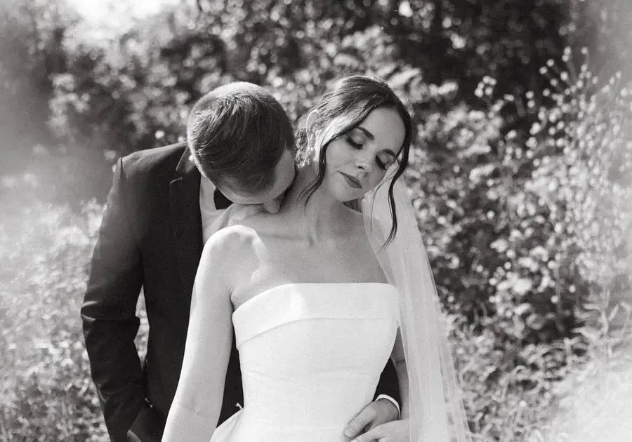 Photo of the groom kissing her bride