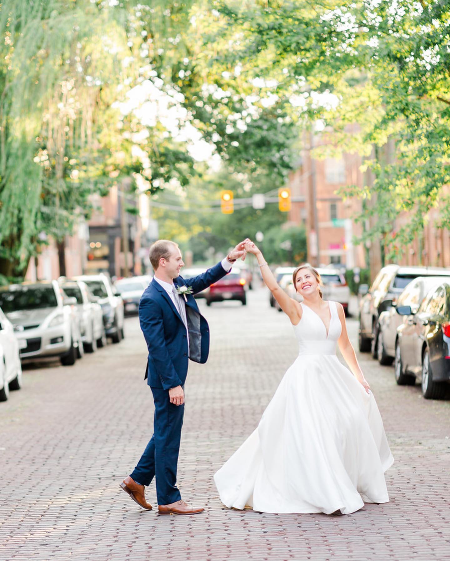Photo of the real bride and groom dancing on the road