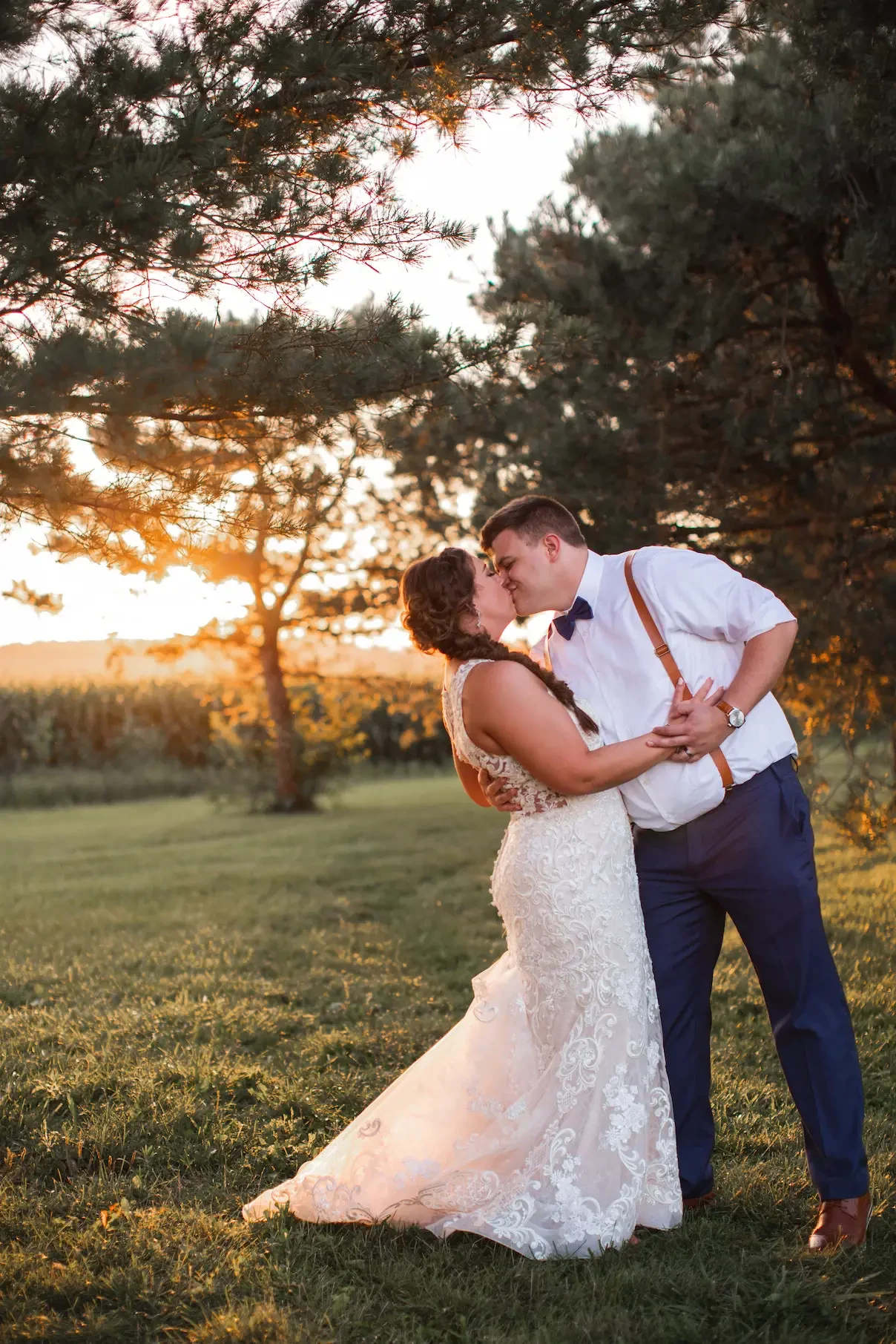 Photo of the real bride and groom kissing in the forest